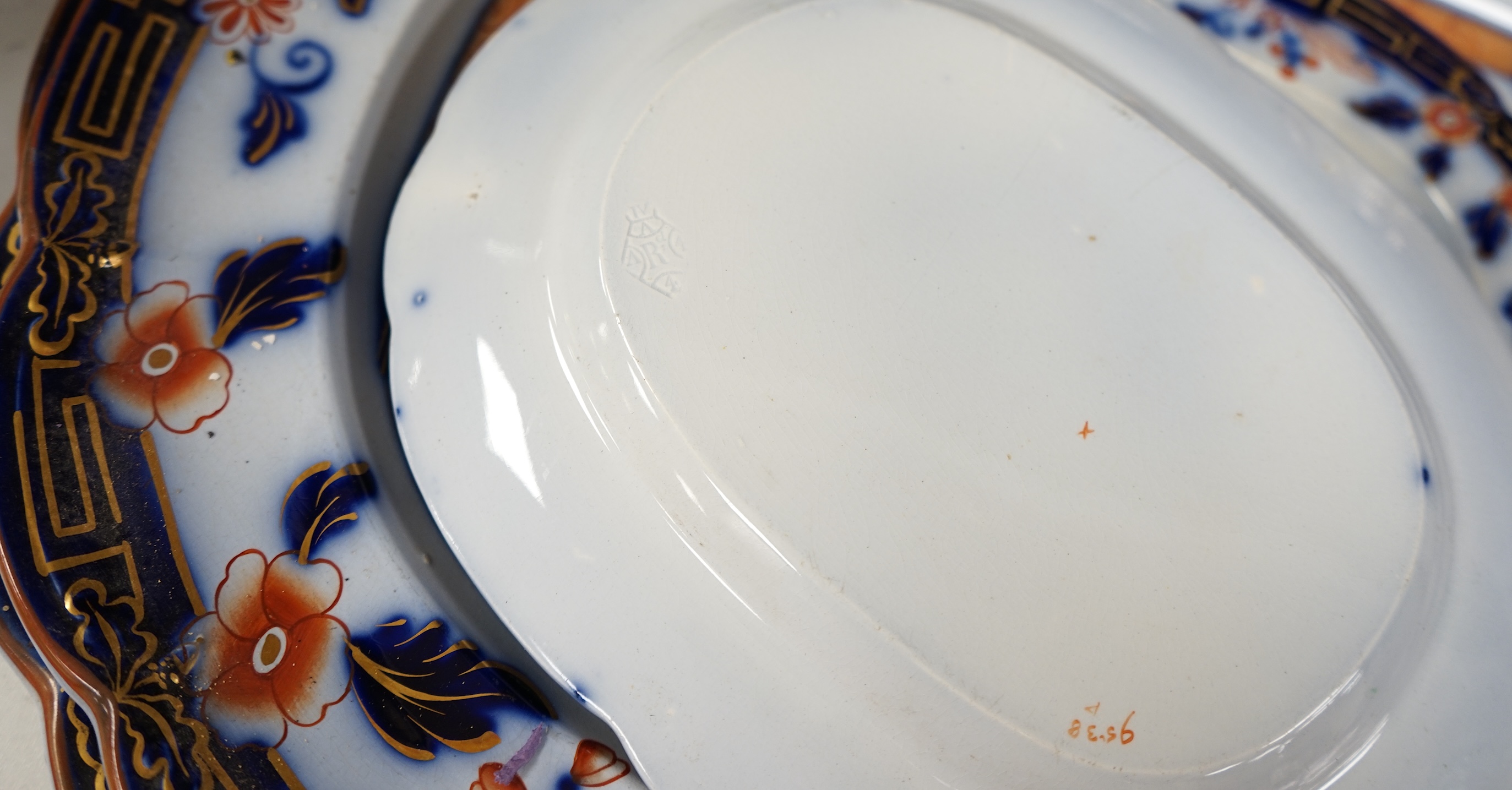 A Staffordshire flow blue ironstone part dinner service, comprising twenty-two 26.5cm diameter plates, seven 23.5cm diameter plates, ten 26.5cm diameter dishes, two small serving dishes and three large serving dishes, la